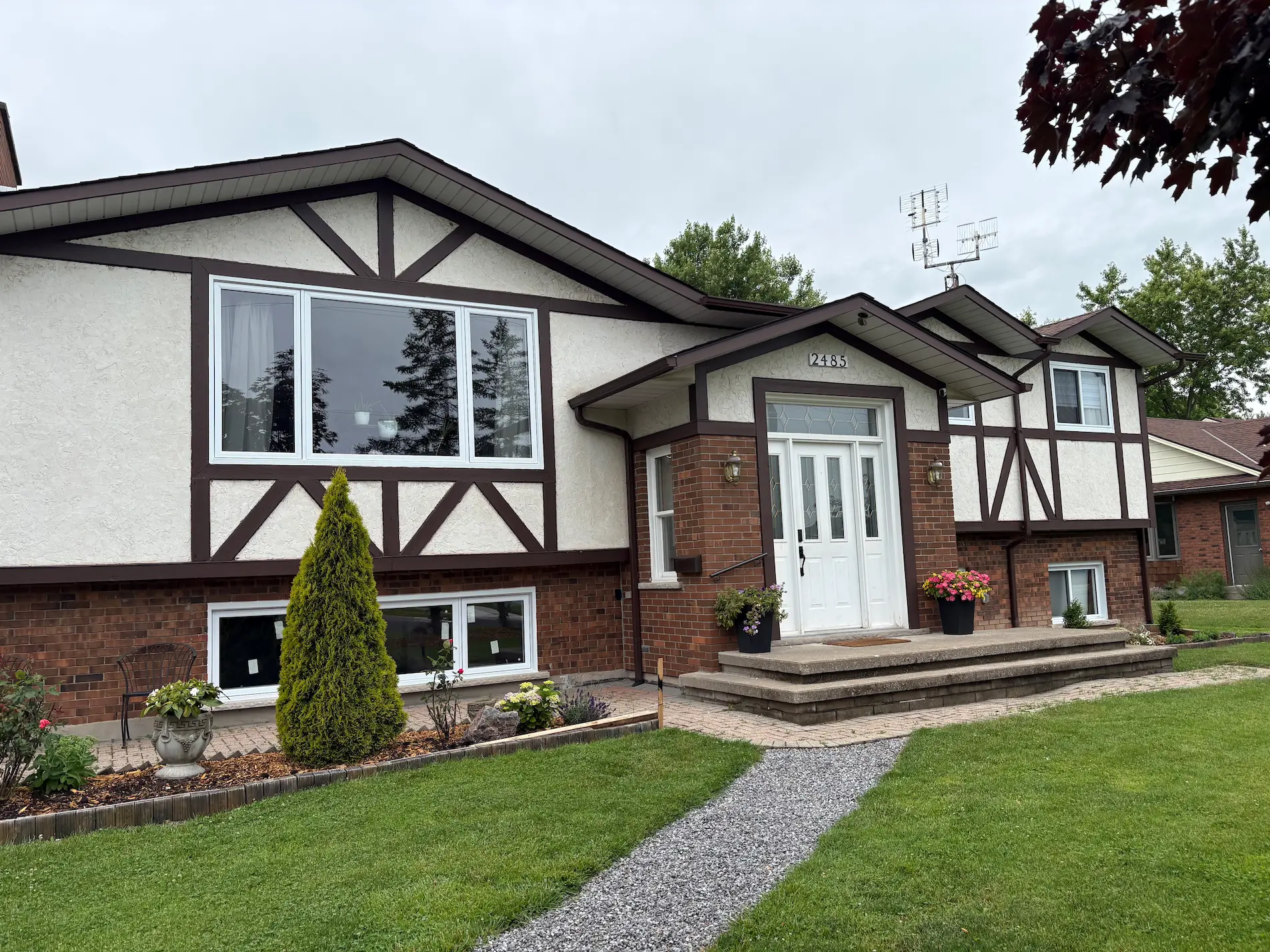 Home exterior before Brownstone siding replacement by Great Northern Home Exteriors