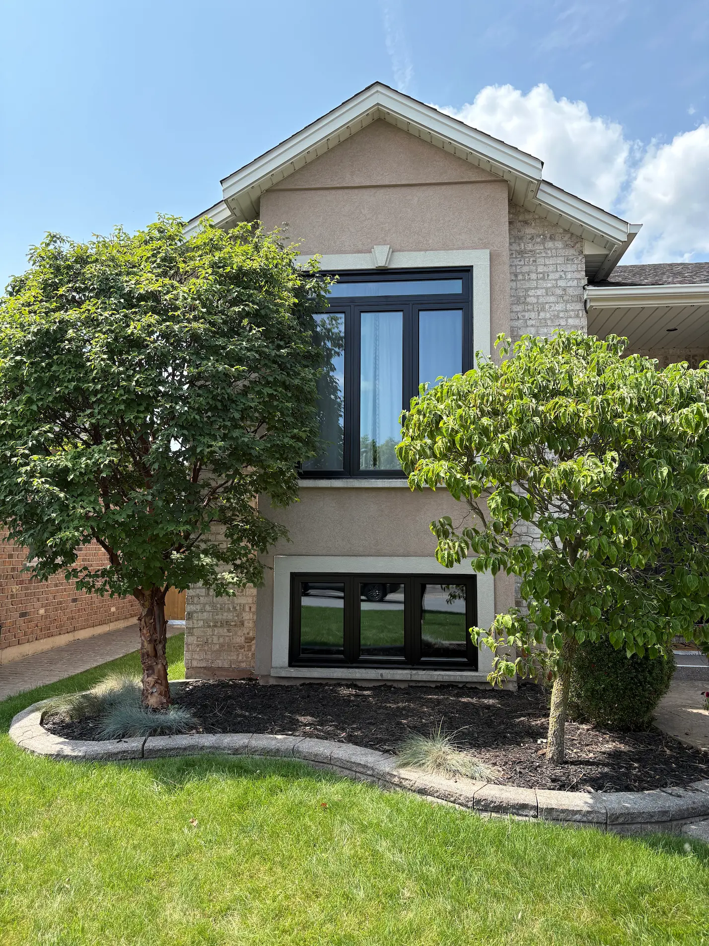 Black KV picture window and basement window installation by Great Northern Home Exteriors