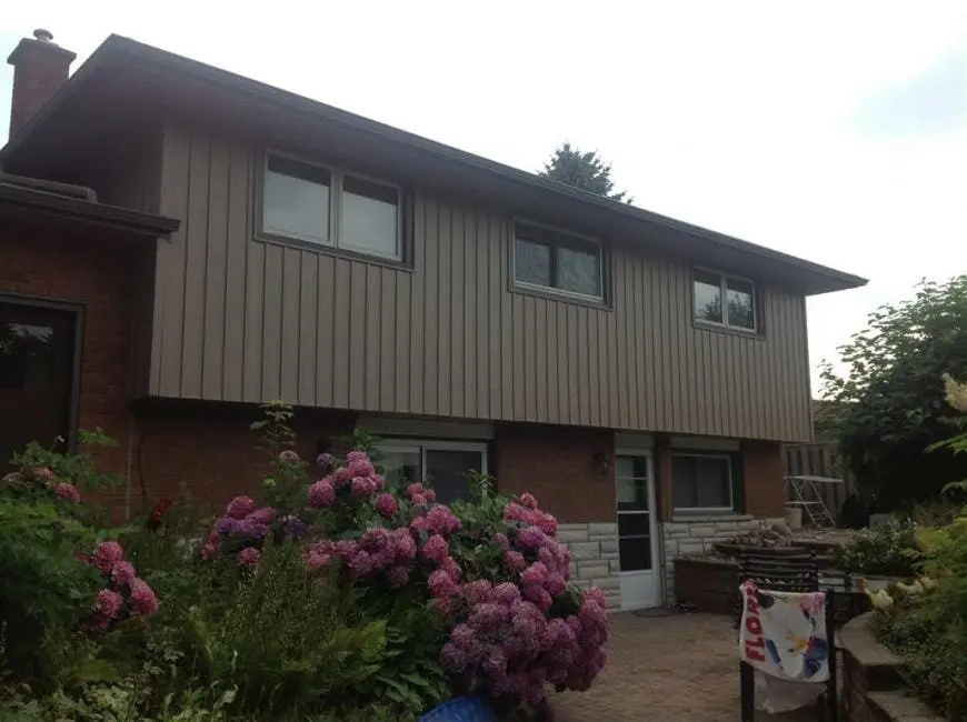 Board and batten vinyl siding installation with clean trim detail by Great Northern Home Exteriors