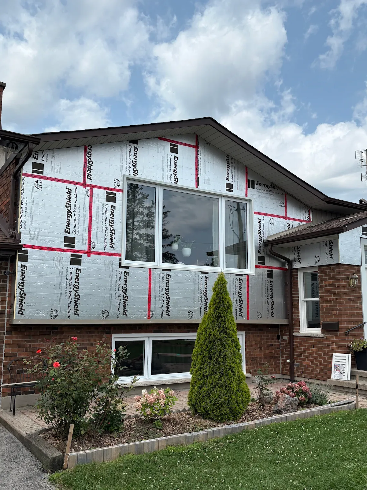 Insulation installed on exterior walls before new siding