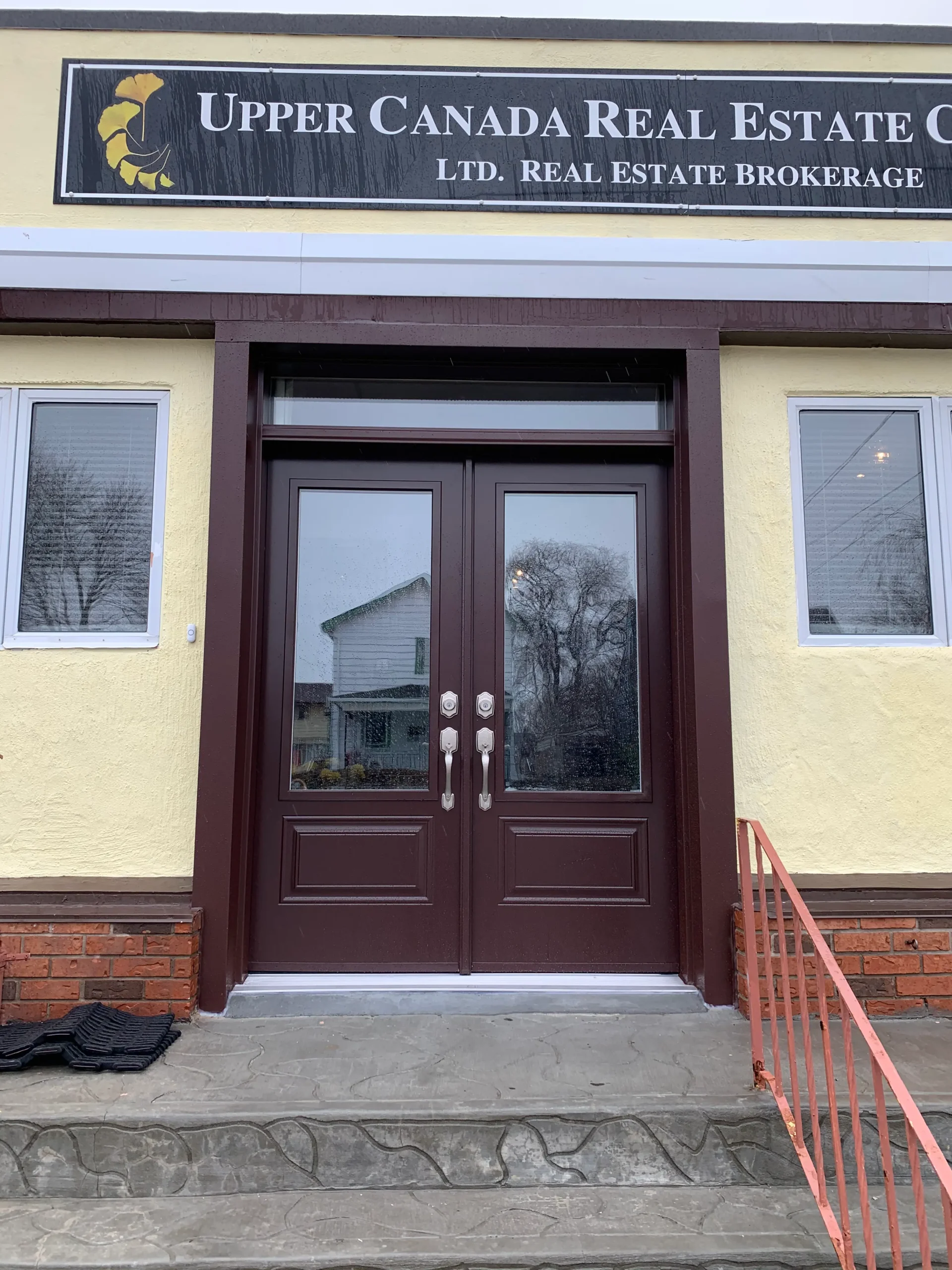 Double entry doors with a transom installed by Great Northern Home Exteriors