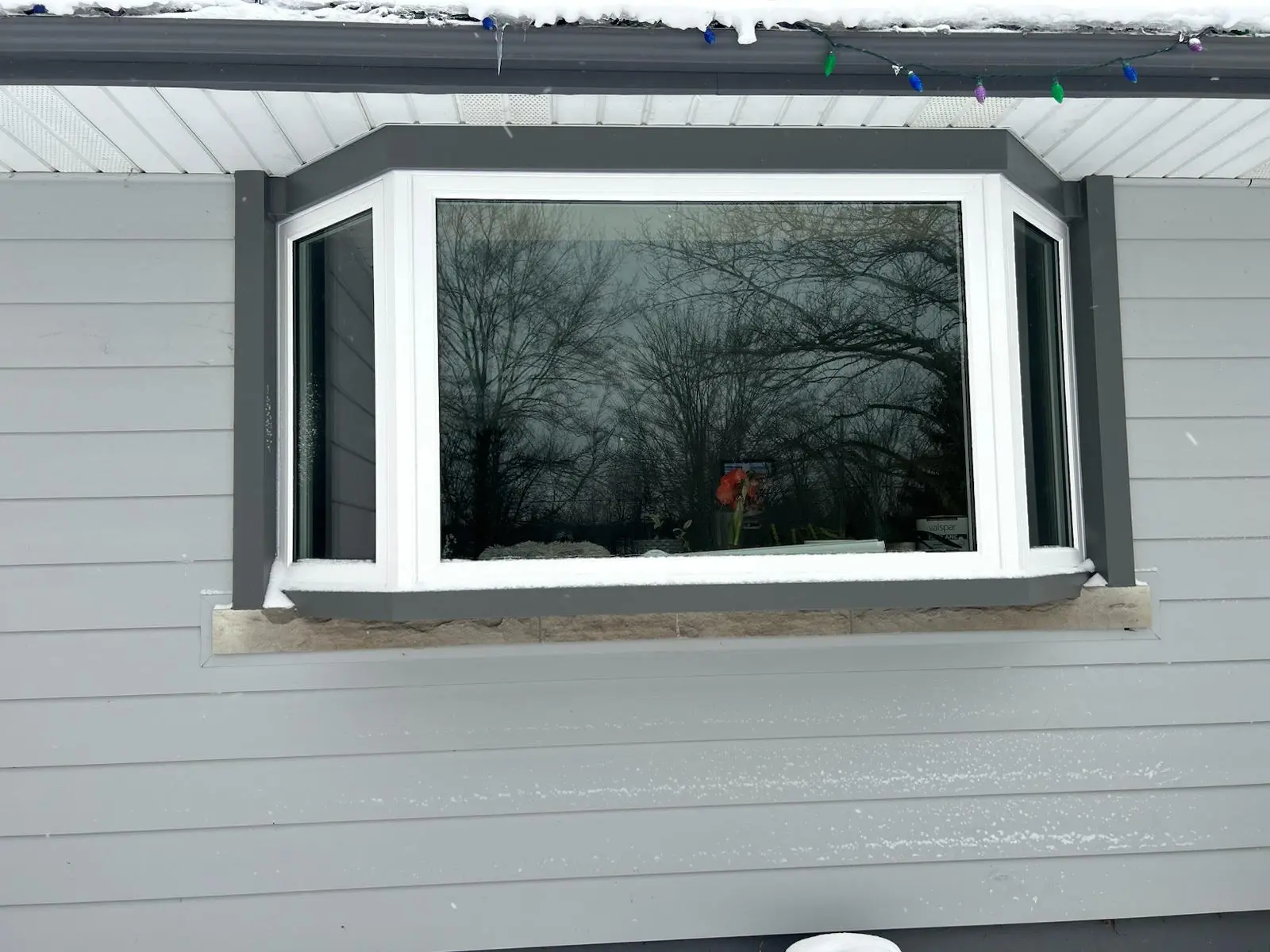 Exterior view of a recently completed bay window installation by Great Northern Home Exteriors