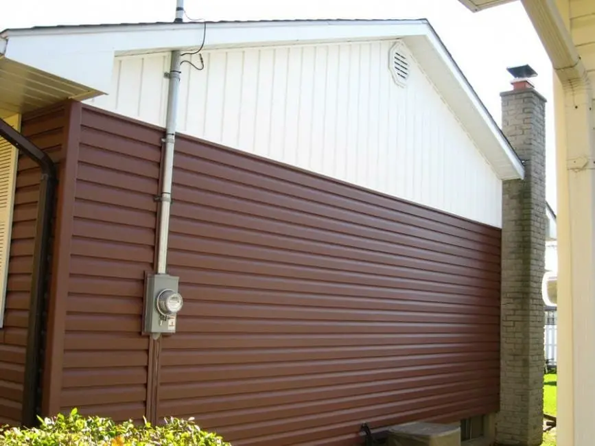 Horizontal siding with white board and batten accents installed by Great Northern Home Exteriors