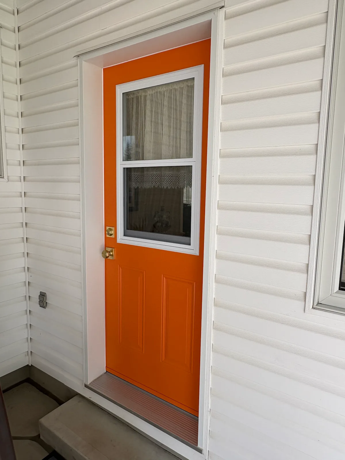Matching orange Dorplex venting entry door installed by GNHE in Niagara Falls