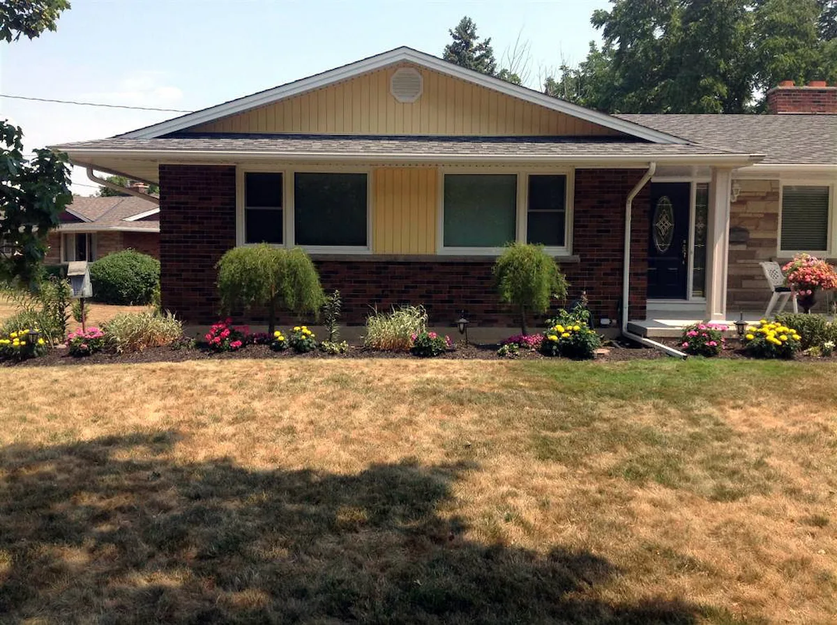 Sunflower vertical siding paired with existing brick and white trim