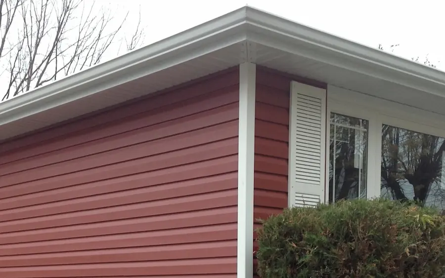 White eavestrough, fascia, soffit and downspout installed by Great Northern Home Exteriors