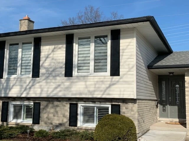 White-Vinyl-Siding-With-Black-Shutters Exterior home with fresh vinyl siding and black shutters installed by Great Northern Home Exteriors in Niagara Falls.