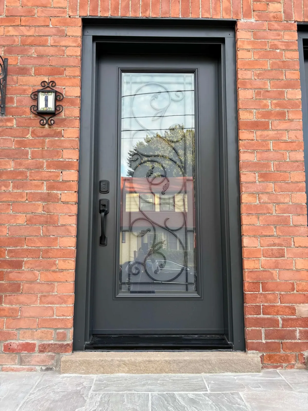 Wrought iron steel entry door exterior view installed by Great Northern Home Exteriors