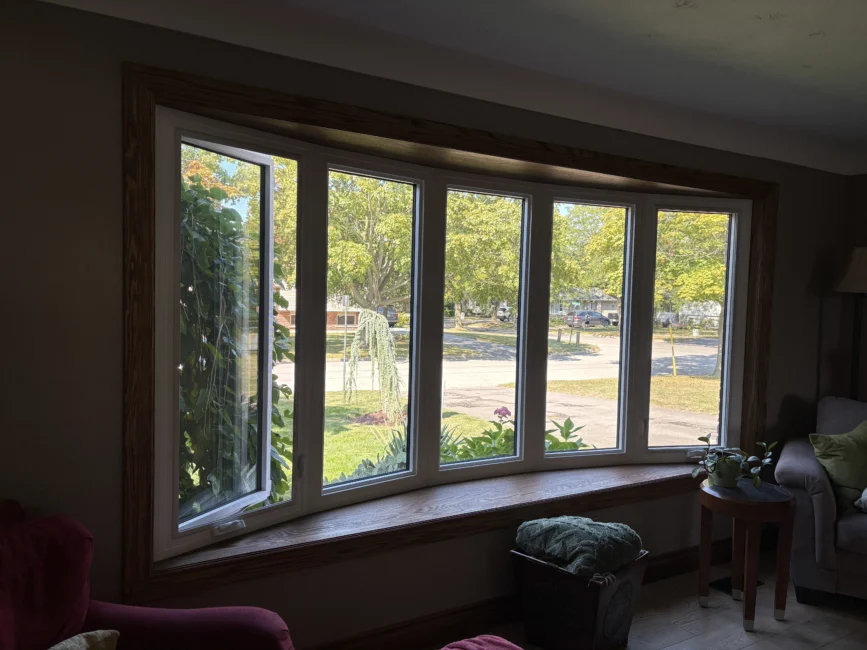 Bow window interior view installation after upgrade with custom oak seat