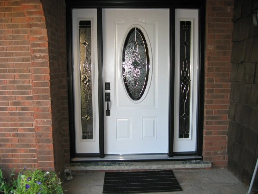 White entry door with decorative glass and sidelites installed by Great Northern Home Exteriors on a home in Fort Erie.