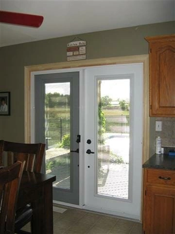 Steel garden door with mini-blinds between the glass installed in a St. Catharines home.